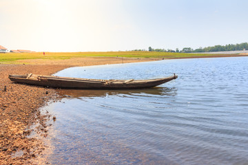 Obraz premium beautiful landscape with wooden boat on the river