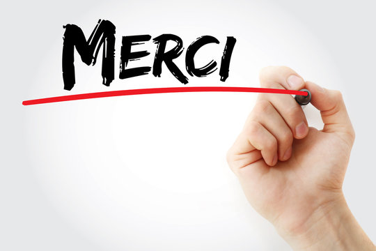 Hand writing Merci (Thank You In French) with marker, concept background