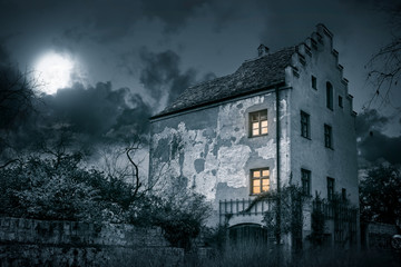 Old mystic haunted house in moonlight