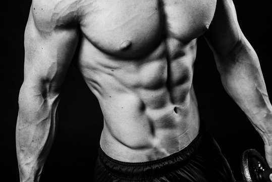 Closeup of cool perfect sexy strong sensual bare torso with abs pectorals 6 pack muscles chest black and white studio, horizontal picture