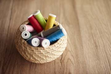 Fototapeta na wymiar Colorful thread spools in the basket