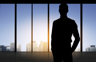 Fototapeta na wymiar silhouette of business man over office background