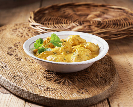 Chicken korma curry in a bowl garnished with coriander