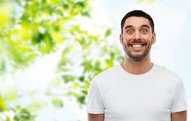 man with funny face over green natural background