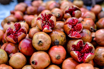 red pomegranates on a street food market in Agra, India