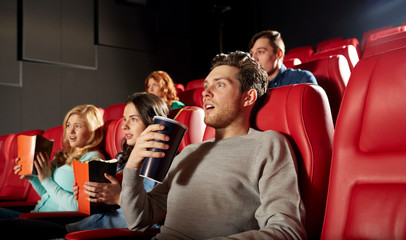 friends watching horror movie in theater