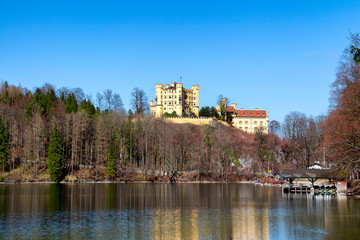 Hohenschwangau Castle, Alpsee lake, landscape view in spring, red maple fall foliage, Bavaria,...