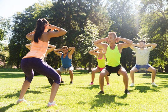 group of friends or sportsmen exercising outdoors