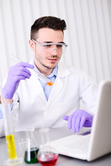 handsome young chemical biologist working in a laboratory