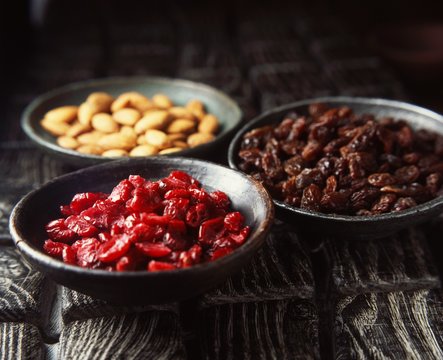 Bowls of dried fruit and nuts, close-up