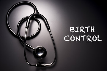 "Birth Control" word with stethoscope on background - health concept. Medical conceptual