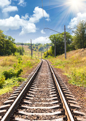 Obraz premium Railway passing through a beautiful landscape in the summer