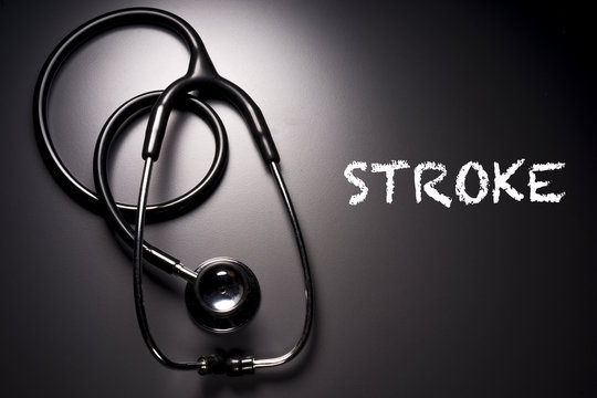 "Stroke" word with stethoscope on background - health concept. Medical conceptual