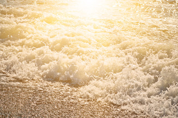 Fototapeta na wymiar Sea wave splashing to the coast, natural vintage sunny background