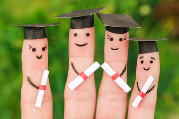 Finger art of students. Graduates holding their diploma after graduation. Toned image 