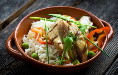 Delicious baked chicken breast and rice with chili and salad