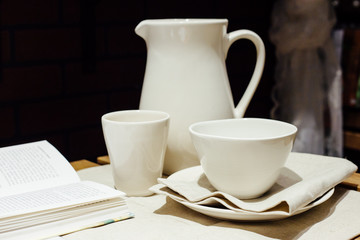 breakfast composition with the book and white service