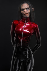 Fototapeta na wymiar Woman in latex clothes with ape mask on face