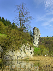 Rock called Hercules Club, limestone cliff in valley of river Pradnik, Ojcow National Park near Krakow in Poland - obrazy, fototapety, plakaty