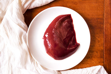 High iron beef liver on a rustic table