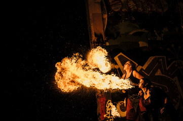 Performers fire breathing in urban area