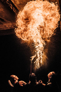 Rear view of performers fire breathing