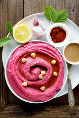 beetroot hummus and spices on a wooden  table