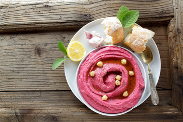 beetroot hummus and spices on a wooden  table