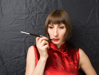 Fototapeta premium woman with a cigarette holder