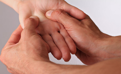 Acupressure. Therapist  doing healing treatment treatment on woman's hand . Alternative medicine,...