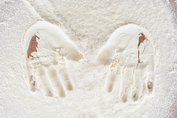 Traces of children's hands on flour