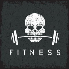 skull holding barbell in the teeth grunge fitness concept