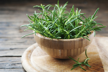 Fresh green rosemary on the wooden table