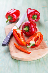 Fresh organic bell peppers on a wooden board