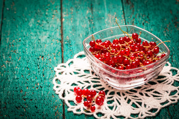 Redcurrant berries on wooden table,healthy food.