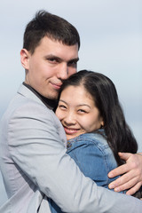Obraz premium European guy embracing Korean girl