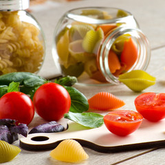 Tomatoes-cherry, Basil and pasta on wooden table
