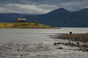 Cabin by the lake and the beginning of the river. Lake Labynkyr. Yakutia. Russia.