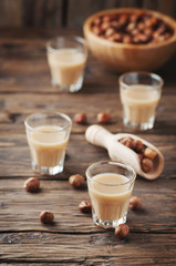 Italian hazelnuts liqueur on the wooden table