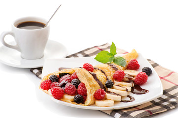 Cup of coffee and pancakes with berries