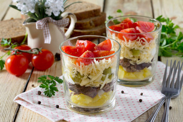 Salad with meat and vegetables on a wooden table, selective focu