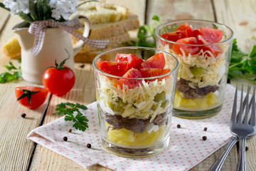 Salad with meat, cheese and vegetables (potatoes, pickled cucumb