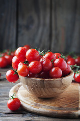 Red tomatoes cherry on the wooden table