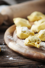 Italian traditional  tortellini on the wooden table