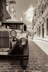 Antique american car in Havana pictured in sepia