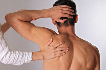 Chiropractic, osteopathy, dorsal manipulation.Therapist  doing healing treatment on man's back....