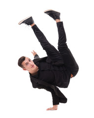 One fit handsome modern style dancer young man working out, performing breakdance moves, hand stand...
