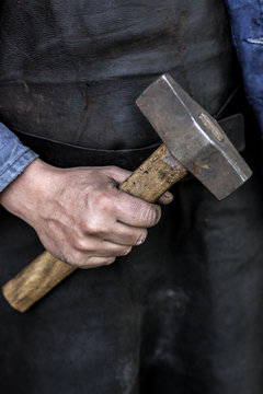 Close up of man's hand holding hammer