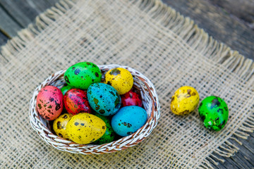painted Easter quail eggs in a basket