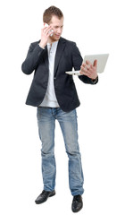 young man standing with laptop and phone